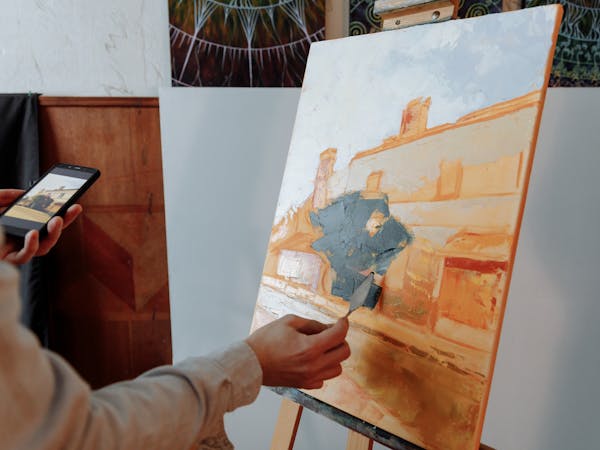 Creative person signing up on laptop with sketchpad