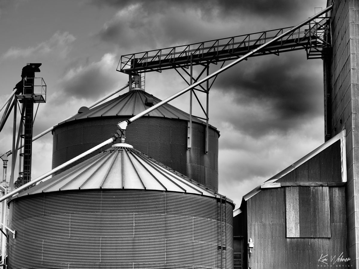 Grain Silos Under Storm Clouds